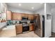 Well-lit kitchen features stainless steel appliances, tile flooring and wood cabinetry at 5145 W Odeum Ln, Phoenix, AZ 85043