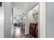 Hall laundry nook featuring a red washing machine, shelf storage, and a doorway to the living room at 5145 W Odeum Ln, Phoenix, AZ 85043