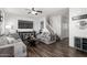 Inviting living room with modern decor, neutral paint, wood floors, and staircase access at 5145 W Odeum Ln, Phoenix, AZ 85043