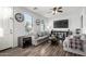Comfortable living room with wood flooring, large windows, and stylish furniture at 5145 W Odeum Ln, Phoenix, AZ 85043