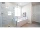 Modern bathroom featuring a walk-in shower, large soaking tub, and marble detailing at 632 W Springfield Pl, Chandler, AZ 85286