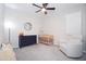 Cozy Bedroom with a ceiling fan, dresser, wooden crib and glider chair creating a warm atmosphere at 632 W Springfield Pl, Chandler, AZ 85286