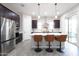 Modern kitchen featuring stainless steel appliances, dark wood cabinets, and a large island with barstool seating at 632 W Springfield Pl, Chandler, AZ 85286