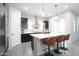 Bright kitchen with a large island, stainless steel appliances, dark wood cabinets, and barstool seating at 632 W Springfield Pl, Chandler, AZ 85286