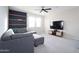 Comfortable living room with a sectional sofa, floating shelves, and a mounted TV at 632 W Springfield Pl, Chandler, AZ 85286