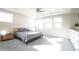 Spacious main bedroom featuring plush carpeting, a ceiling fan, and sun-drenched windows at 632 W Springfield Pl, Chandler, AZ 85286