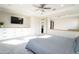 Comfortable main bedroom with built-in storage, television, and ceiling fan at 632 W Springfield Pl, Chandler, AZ 85286
