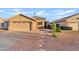 Single-story home with low maintenance desert landscaping and attached two-car garage at 692 E Cantebria Dr, Gilbert, AZ 85296