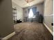 Well-lit room with a large window, fan, and a shelf unit for storage at 6943 W Devonshire Ave # 1355, Phoenix, AZ 85033