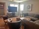 Cozy living area with a large television, comfortable seating, and warm lighting at 6943 W Devonshire Ave # 1355, Phoenix, AZ 85033