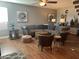 Comfortable living room with a large sectional sofa, stylish chairs, and hardwood floors at 6943 W Devonshire Ave # 1355, Phoenix, AZ 85033