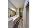 This bathroom features a double vanity, wood floors, mirrors, and lights at 723 E Whitten St, Chandler, AZ 85225