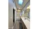 Bright bathroom features a skylight, wood-look floors, a shower-tub combo, and a vanity with framed mirror at 723 E Whitten St, Chandler, AZ 85225