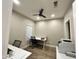 This bedroom features a ceiling fan, neutral walls, wood floors, and a window with blinds at 723 E Whitten St, Chandler, AZ 85225