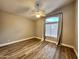 A bedroom with light walls, wood floors, a ceiling fan, and a window with blinds at 723 E Whitten St, Chandler, AZ 85225