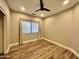 This is a bedroom with light gray walls, wooden floors, and a window with blinds at 723 E Whitten St, Chandler, AZ 85225