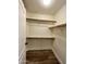 A white closet with wood floors, white walls, and wooden shelves and rods at 723 E Whitten St, Chandler, AZ 85225