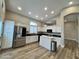 Spacious kitchen with stainless steel appliances, central island, and modern countertops at 723 E Whitten St, Chandler, AZ 85225