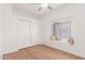 Serene bedroom with hardwood floors, closet, and a cozy window seat at 824 N Williams Cir, Mesa, AZ 85203