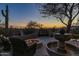 A backyard oasis featuring a fire pit, water fountain, and comfortable seating under a starlit sky at 8540 E Mcdowell Rd # 125, Mesa, AZ 85207