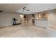 Finished basement with a ceiling fan, tile flooring, a dry bar, and space for a home gym at 8540 E Mcdowell Rd # 125, Mesa, AZ 85207