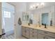 Spacious bathroom featuring a double sink vanity with white countertops and modern fixtures at 8540 E Mcdowell Rd # 125, Mesa, AZ 85207