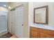 Well-lit bathroom with a vanity, marble countertop, framed mirror, and a sliding door shower at 8540 E Mcdowell Rd # 125, Mesa, AZ 85207