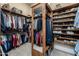 Walk-in closet with custom shelving for shoes, clothes, and accessories at 8540 E Mcdowell Rd # 125, Mesa, AZ 85207