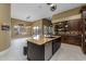 A complete kitchen view featuring an island, stainless steel appliances, custom cabinets, and a dining space at 8540 E Mcdowell Rd # 125, Mesa, AZ 85207