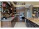 Gourmet kitchen featuring custom cabinets, stainless steel appliances, and a granite-topped center island at 8540 E Mcdowell Rd # 125, Mesa, AZ 85207