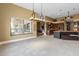 Spacious kitchen and living space featuring an island, custom cabinets, and stainless steel appliances at 8540 E Mcdowell Rd # 125, Mesa, AZ 85207