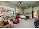 Main bedroom featuring ceiling fans, sitting area, and comfortable furniture at 8540 E Mcdowell Rd # 125, Mesa, AZ 85207