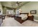 Large main bedroom with ceiling fans, sitting area, and neutral carpeting at 8540 E Mcdowell Rd # 125, Mesa, AZ 85207