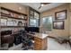 Comfortable home office boasts custom shelves and a wooden desk with a natural view at 8540 E Mcdowell Rd # 125, Mesa, AZ 85207