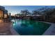Inviting private pool featuring a waterfall and stone accents with ambient lighting, perfect for relaxation at 8540 E Mcdowell Rd # 125, Mesa, AZ 85207