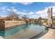 Beautiful swimming pool with a waterfall feature and surrounding patio area for relaxing at 8540 E Mcdowell Rd # 125, Mesa, AZ 85207