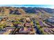 Scenic aerial view of a residential neighborhood with lush desert landscaping and majestic mountain backdrop at 9013 S 15Th Way, Phoenix, AZ 85042