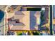 Aerial view of a tile roof with outdoor dining, a small backyard with artificial turf, and desert plants at 9013 S 15Th Way, Phoenix, AZ 85042