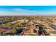 Extensive aerial view of a vibrant suburban neighborhood, showing modern home styles with the city skyline in the distance at 9013 S 15Th Way, Phoenix, AZ 85042