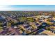 Overhead view of a community showcasing many homes with tile roofs, desert landscape, and nearby mountain views at 9013 S 15Th Way, Phoenix, AZ 85042