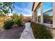 Landscaped backyard with a stone walkway, lush greenery, and mature trees at 9013 S 15Th Way, Phoenix, AZ 85042