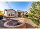 Large backyard featuring low-maintenance desert landscaping, a fire pit, and a covered patio at 9013 S 15Th Way, Phoenix, AZ 85042