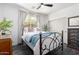 This bedroom boasts a warm ambiance with a stylish bed frame and bright natural lighting at 9013 S 15Th Way, Phoenix, AZ 85042