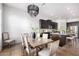 Elegant dining room with a wooden table, seating for six, and stylish lighting fixture at 9013 S 15Th Way, Phoenix, AZ 85042