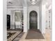 Elegant home entryway with a dark wood door, textured rug, and modern lighting fixture at 9013 S 15Th Way, Phoenix, AZ 85042