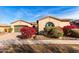 Stunning single-Gathering home featuring colorful landscaping, terracotta roofing, and a brick driveway at 9013 S 15Th Way, Phoenix, AZ 85042