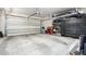 Spacious two-car garage with ample storage solutions, including shelving and cabinets at 9013 S 15Th Way, Phoenix, AZ 85042