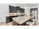 Granite island with seating, modern kitchen features wine cooler, dark cabinets, and stainless appliances at 9013 S 15Th Way, Phoenix, AZ 85042