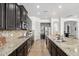 Galley kitchen boasts stainless appliances, granite countertops, and ample cabinet storage space at 9013 S 15Th Way, Phoenix, AZ 85042