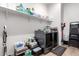 A clean and organized laundry room with modern washer and dryer, ample shelving, and convenient storage solutions at 9013 S 15Th Way, Phoenix, AZ 85042